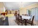 Open-concept dining room with access to the backyard and views of the kitchen at 24536 Buckingham Way, Port Charlotte, FL 33980