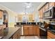 Well-lit kitchen with stainless steel appliances, granite countertops, and a breakfast nook at 24536 Buckingham Way, Port Charlotte, FL 33980