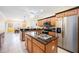 Spacious kitchen featuring granite countertops, stainless appliances, and open to the dining area at 24536 Buckingham Way, Port Charlotte, FL 33980