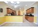 Well-lit kitchen with tile floors, wooden cabinets, and granite countertops at 24536 Buckingham Way, Port Charlotte, FL 33980