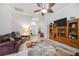Bright living room showcasing tile floors, archways, and a wooden entertainment center at 24536 Buckingham Way, Port Charlotte, FL 33980