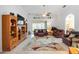 Spacious living room featuring tile flooring, comfortable furniture, and access to an enclosed lanai at 24536 Buckingham Way, Port Charlotte, FL 33980