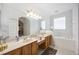 Main bathroom with double sinks, soaking tub, vanity space, large mirrors, and neutral decor at 24536 Buckingham Way, Port Charlotte, FL 33980