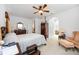 Bright and airy main bedroom with neutral walls, ceiling fan, and decorative furnishings at 24536 Buckingham Way, Port Charlotte, FL 33980