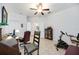 Spacious home office with tile floors, a ceiling fan, and multiple workstations at 24536 Buckingham Way, Port Charlotte, FL 33980
