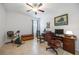Well-lit home office featuring a ceiling fan, tile floors, exercise equipment and a work station at 24536 Buckingham Way, Port Charlotte, FL 33980