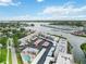Aerial view of the condo community with boat docks, carports, pool, and water views at 250 Santa Maria St # 314, Venice, FL 34285