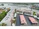 An aerial view of a waterfront condo building with boat docks, showcasing the property's location and parking at 250 Santa Maria St # 314, Venice, FL 34285