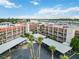 Aerial view of a multi-unit building, showing parking, landscaping, and access to waterways at 250 Santa Maria St # 314, Venice, FL 34285