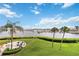Beautiful backyard with seating, lawn and waterfront views of boats, palm trees and intercoastal waterway at 250 Santa Maria St # 314, Venice, FL 34285