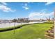 Scenic backyard showcasing a lush green lawn, palm trees and calming views of the marina at 250 Santa Maria St # 314, Venice, FL 34285