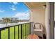 Balcony featuring a chair, table and railing with a view of the intercoastal waterway and buildings at 250 Santa Maria St # 314, Venice, FL 34285