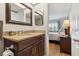 Bathroom with granite countertop sink and open view to bedroom at 250 Santa Maria St # 314, Venice, FL 34285