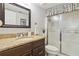 Bathroom featuring a granite countertop vanity and a walk-in shower with a decorative curtain rod at 250 Santa Maria St # 314, Venice, FL 34285