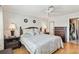 This bedroom has a ceiling fan, bedside lamps, and wood floors at 250 Santa Maria St # 314, Venice, FL 34285