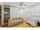 Bright bedroom featuring a Murphy bed, built-in shelving, and a window with plantation shutters at 250 Santa Maria St # 314, Venice, FL 34285