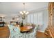 Dining area with elegant light fixture and shuttered windows at 250 Santa Maria St # 314, Venice, FL 34285
