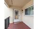 A welcoming condo entrance with a glass door, shutters, and a decorative wreath, offering curb appeal at 250 Santa Maria St # 314, Venice, FL 34285
