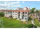 Well-maintained condo building with red tile roof, lush landscaping, and manicured lawns at 250 Santa Maria St # 314, Venice, FL 34285
