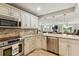 Bright kitchen with white cabinets, stainless appliances and tan granite countertops at 250 Santa Maria St # 314, Venice, FL 34285