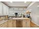 Bright kitchen with white cabinets, stainless appliances and tan granite countertops at 250 Santa Maria St # 314, Venice, FL 34285