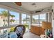 Glass enclosed lanai with beautiful water views, ceiling fan, and tiled flooring at 250 Santa Maria St # 314, Venice, FL 34285