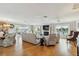 Open-concept living area featuring water views, a fireplace, and hardwood floors, creating a cozy atmosphere at 250 Santa Maria St # 314, Venice, FL 34285