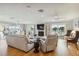A modern living room with water views, a fireplace, and hardwood floors, perfect for comfortable living at 250 Santa Maria St # 314, Venice, FL 34285