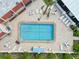 Aerial view of a refreshing pool surrounded by lounge chairs and lush landscaping, perfect for relaxation and leisure at 250 Santa Maria St # 314, Venice, FL 34285