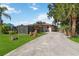 A fenced backyard offers privacy, complemented by mature landscaping and a concrete driveway for easy access at 2555 Yucca Rd, Venice, FL 34293