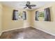 Comfortable bedroom with natural light from two windows and a ceiling fan at 2555 Yucca Rd, Venice, FL 34293