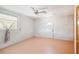 Simple bedroom with a ceiling fan, natural light from the window, and neutral paint at 2555 Yucca Rd, Venice, FL 34293