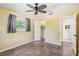 Cozy bedroom with ceiling fan, closet and en-suite bathroom at 2555 Yucca Rd, Venice, FL 34293