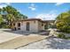 A cozy home showcasing a carport and gravel landscaping for low maintenance, with a glimpse of a fenced backyard at 2555 Yucca Rd, Venice, FL 34293