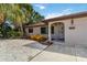 Close up of a well-kept house with xeriscaping and a unique oval front door, enhancing the property's appeal at 2555 Yucca Rd, Venice, FL 34293