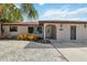 Charming house with front door access with decorative gravel and xeriscaping that creates an inviting entrance at 2555 Yucca Rd, Venice, FL 34293