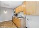 Bright kitchen with wood cabinets, stainless steel sink, and essential appliances for convenient living at 2555 Yucca Rd, Venice, FL 34293