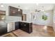 Stylish kitchen boasts stainless appliances, dark cabinets, and bright pendant lighting at 2555 Yucca Rd, Venice, FL 34293