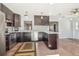 Stylish kitchen boasts stainless appliances, dark cabinets, and bright pendant lighting at 2555 Yucca Rd, Venice, FL 34293