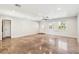 Bright living room featuring sleek floors, large windows, and a modern ceiling fan for comfort and style at 2555 Yucca Rd, Venice, FL 34293