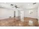 Bright living room features polished floors, a modern ceiling fan, and neutral wall paint at 2555 Yucca Rd, Venice, FL 34293
