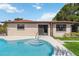 Inviting backyard pool featuring a tanning ledge and convenient access to the home's sliding glass doors at 2555 Yucca Rd, Venice, FL 34293
