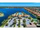 Aerial view of the community clubhouse, pool, and surrounding lakefront homes at 257 Teramo Way, Nokomis, FL 34275