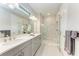 Modern bathroom with double vanity, tiled shower, and decorative details showcasing a serene and luxurious space at 257 Teramo Way, Nokomis, FL 34275