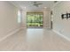 Light-filled bedroom featuring wood look floors, ceiling fan, and sliding doors at 257 Teramo Way, Nokomis, FL 34275