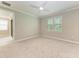Bright bedroom with a large window and a view, carpet, ceiling fan, and neutral decor at 257 Teramo Way, Nokomis, FL 34275
