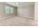 Cozy carpeted bedroom has a large window that offers great natural light, enhancing the room's airy ambiance at 257 Teramo Way, Nokomis, FL 34275