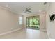 Bedroom with wood look floors, ceiling fan, and sliding doors to the patio at 257 Teramo Way, Nokomis, FL 34275