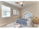 Cozy bedroom features a cute bed frame and decor and natural light from the large window at 257 Teramo Way, Nokomis, FL 34275