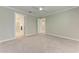 Serene carpeted bedroom with a ceiling fan and an ensuite bathroom entry offers comfort and privacy at 257 Teramo Way, Nokomis, FL 34275